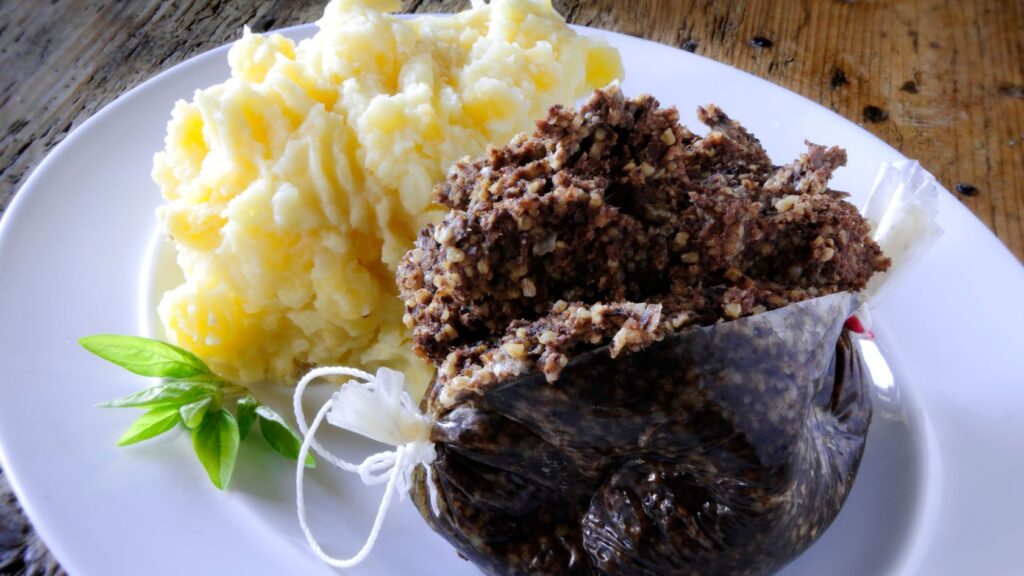 Unusual foods- Scottish haggis meal with neeps and tatties on a plate.