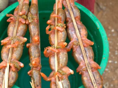 unusual foods. Cooked frogs on a skewer